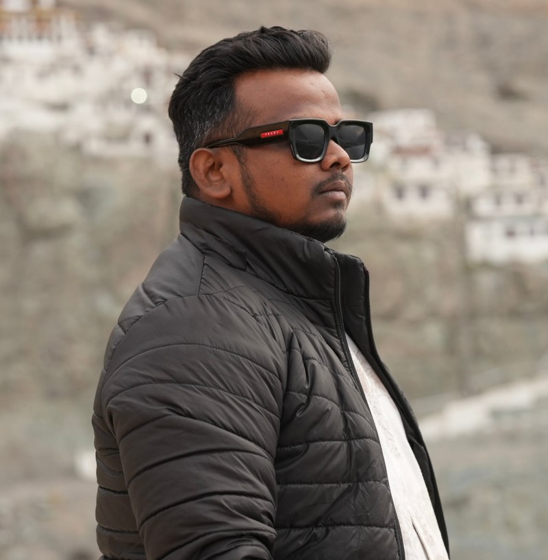 Akash Bhore, Director of Photography, in sunglasses and a black jacket outdoors
