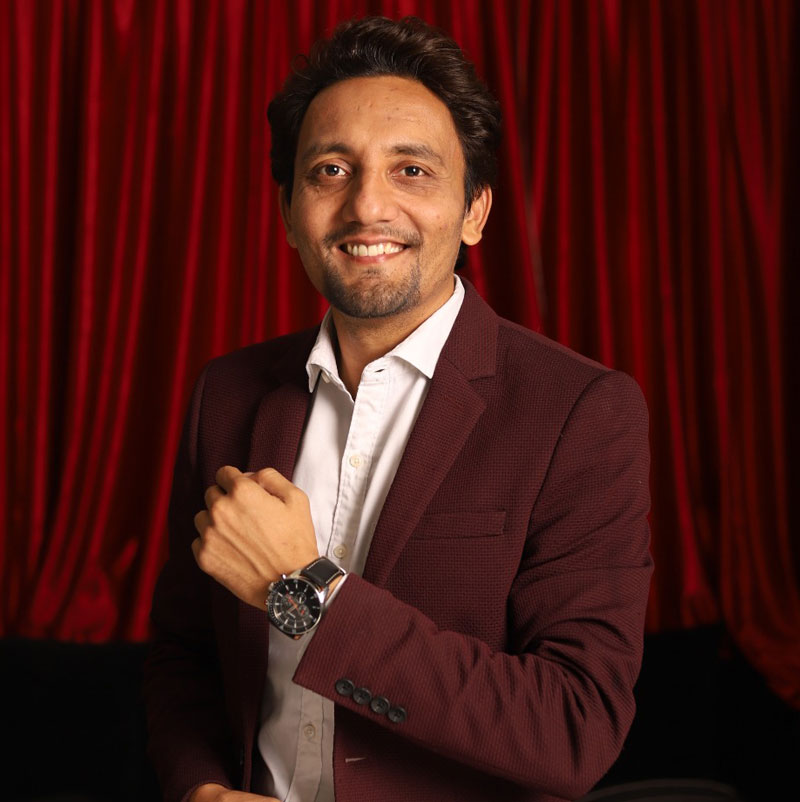 Manish Jain, Founder and CEO of Satkar Software Solutions, smiling in a maroon blazer