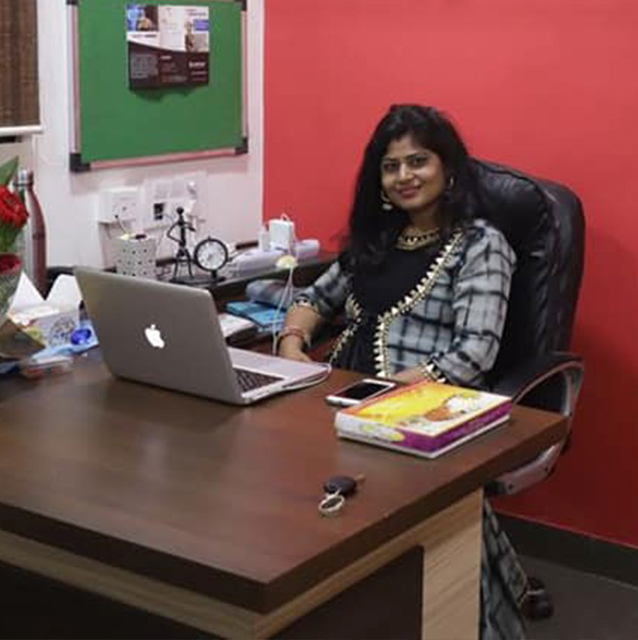 Sapna Jain, Co-Founder, seated at her office desk with a laptop